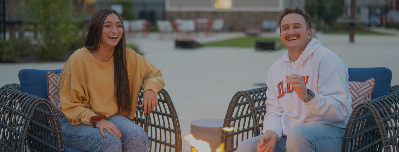 Young woman and man sitting and laughing