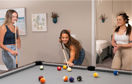 Group of female friends playing pool