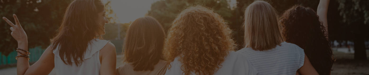 Group of women hugging with their backs to the camera